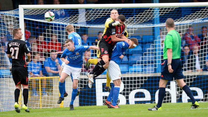 Crusaders 'keeper Se&aacute;n O'Neill gets a fist onto the ball during the north Belfast's side win over Glenavon at Mournview Park on Saturday <br />Picture: Pacemaker&nbsp;