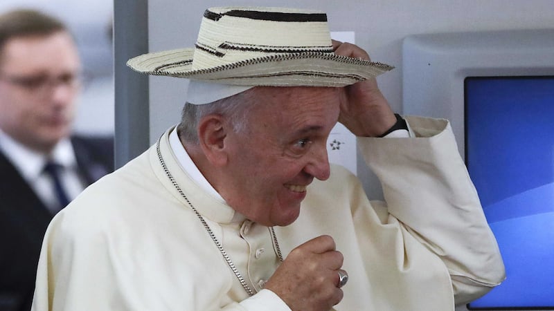 Pope Francis wears a sombrero from Panama which was donated to him by a journalist on board the flight from Krakow, Poland, to Rome, at the end of his 5-day trip to southern Poland. Picture by Gregorio Borgia, Associated Press&nbsp;