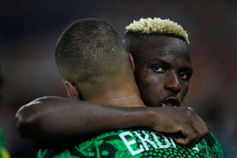 Nigeria’s Victor Osimhen consoles team-mate William Troost-Ekong after the 2-1 African Cup of Nations final defeat against Ivory Coast (Themba Hadebe/AP)