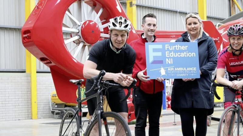 Damien McAnespie from Air Ambulance NI and Grace Neville of NI&#39;s Further Education Colleges, pictured with members of the &lsquo;Further Education 400&rsquo; team 
