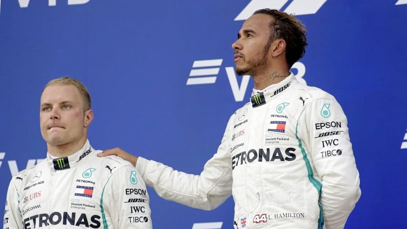 Lewis Hamilton (right) with his Mercedes team-mate Valtteri Bottas after team orders gave the former victory in the Russian Grand Prix. 