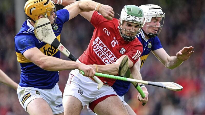 Shane Kingston of Cork is tackled by Tipperary players Ronan Maher, left, and Seamus Kennedy. 