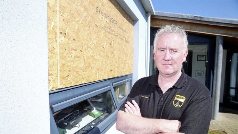 Pilib Mist&eacute;il, principal of Bunscoil an tSl&eacute;ibhe Dhuibh, beside one of the windows smashed by burglars. Picture by Mal McCann 
