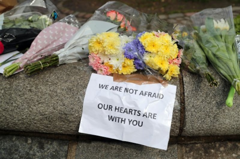 Flowers outside the Queen Elizabeth II Centre in London, after seven people were arrested in raids in London, Birmingham and elsewhere linked to the Westminster terror attack (Gareth Fuller/PA)