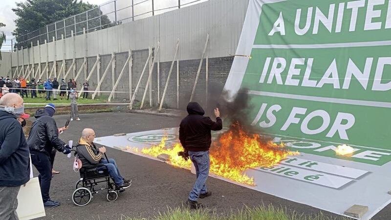 A united Ireland banner is torched by loyalists at an anti- Protocol rally on the Shankill Road in Belfast 
