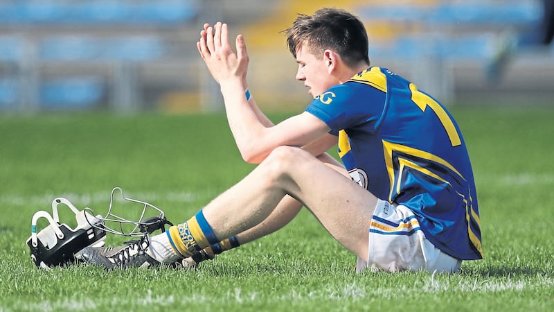 A dejected Conal Doherty-Cunning sits on the Semple Stadium turf after St Louis&rsquo;, Ballymena&rsquo;s All-Ireland final defeat to Abbey CBS yesterday