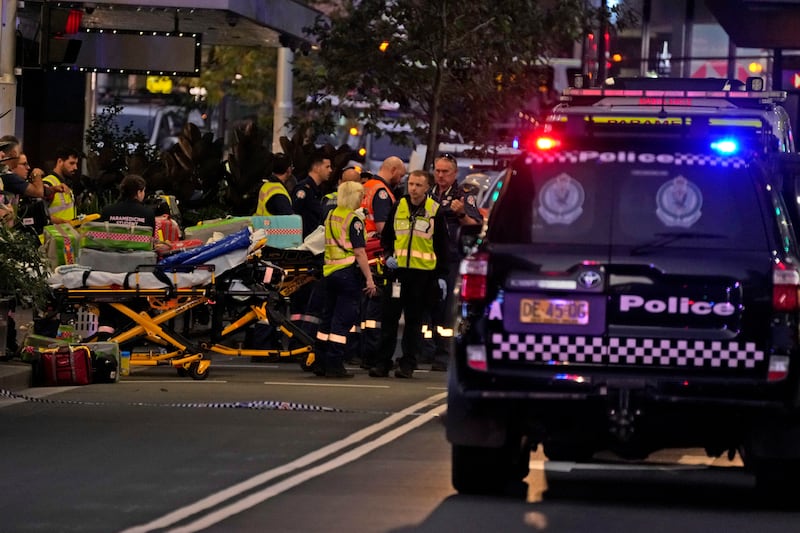 Emergency officers stand by with stretchers outside Westfield Shopping Centre (Rick Rycroft/AP)