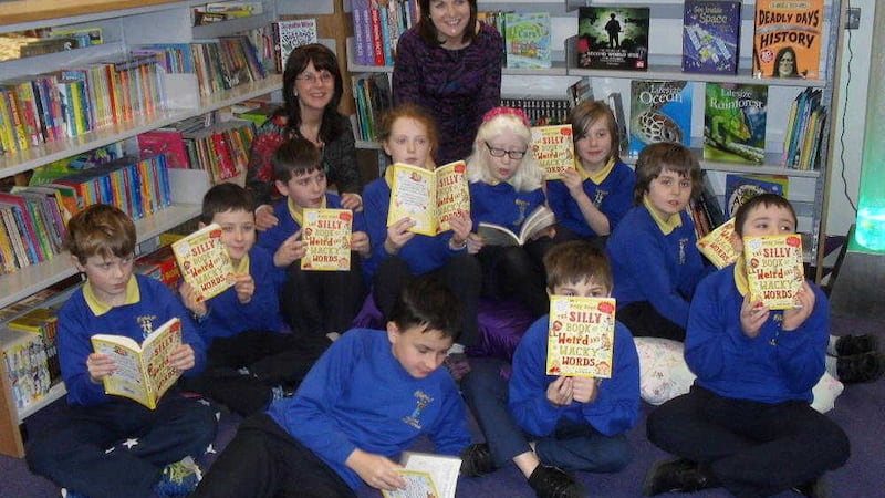 Pauline Burgess (left) and Liz Canning from Booktrust NI with children from Millennium IPS 