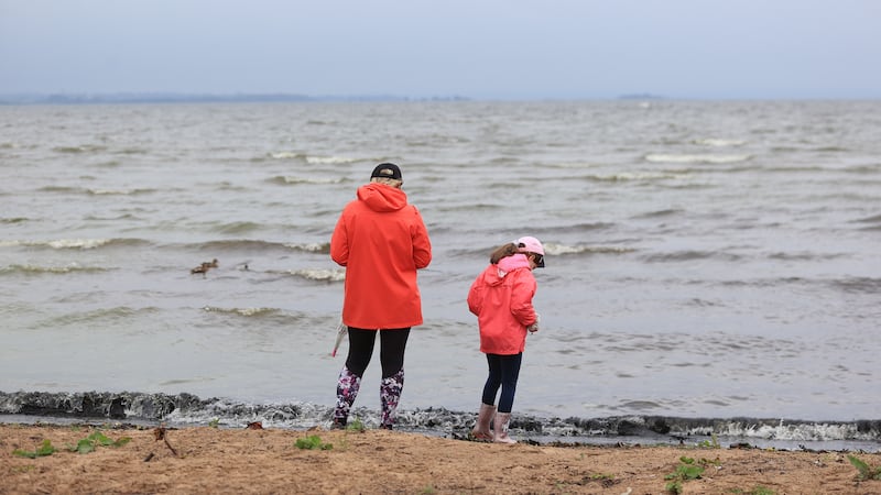 A woman and young girl on the shore of Ballyronan beach on Lough Neagh