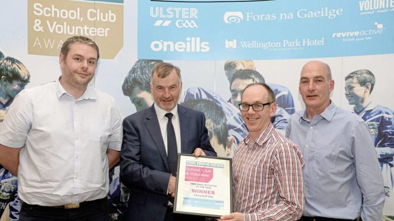 Niall Ferguson, Andrew Moohan and Marius Mulligan from Carryduff GAC are presented their award for Best Underage Initiative at the Irish News School, Club &amp; Volunteer Awards by Malachy Toner of the Wellington Park Hotel.