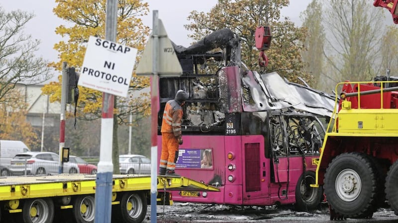 The wreckage of a bus being removed after it was hijacked and set on fire in Newtownabbey on Sunday night. Picture by Hugh Russell