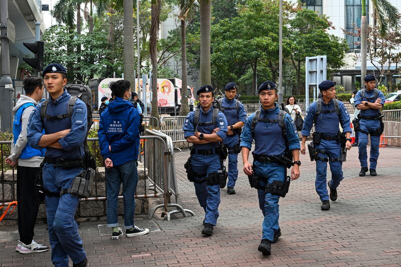 Police officers patrol outside the West Kowloon Magistrates’ Courts (Billy HC Kwok/AP)