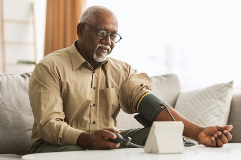 A man reading his own blood pressure.