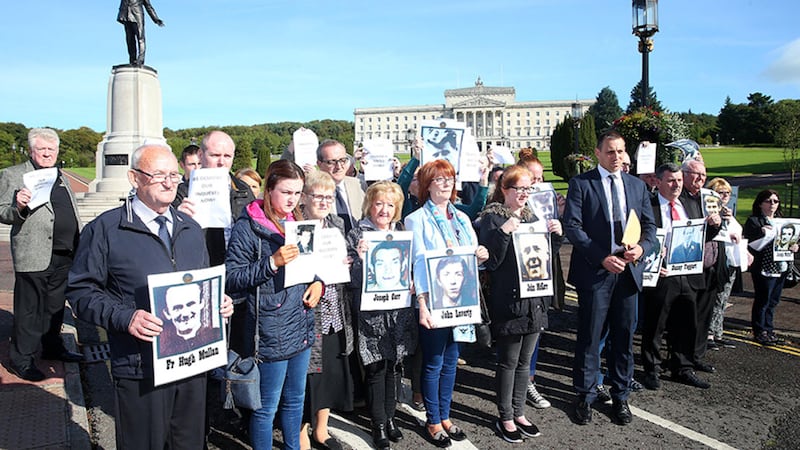&nbsp;<span style="font-family: Arial, sans-serif; ">Families held up photographs of their deceased relatives during the protest at Stormont today</span>