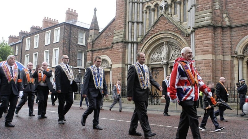 Members of the Orange Order marching past St Patrick's Church on Donegall Street in Belfast. Picture by Matt Bohill