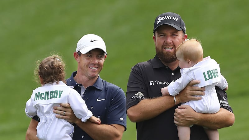 Rory McIIroy (left) carries his daughter Poppy Kennedy, while Shane Lowry carries his daughter Ivy down the first fairway during the Masters golf tournament Par-3 contest at Augusta National Golf Club on Wednesday. The start of play was delayed on Thursday due to bad weather at Augusta<br />Picture: AP&nbsp;