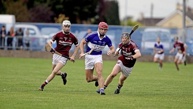 St John&#39;s Micheal Bradley comes under pressure from Ruairi Ogs Francis McCurry and Fergus McCambridge at Dunloy. Picture: Seamus Loughran 