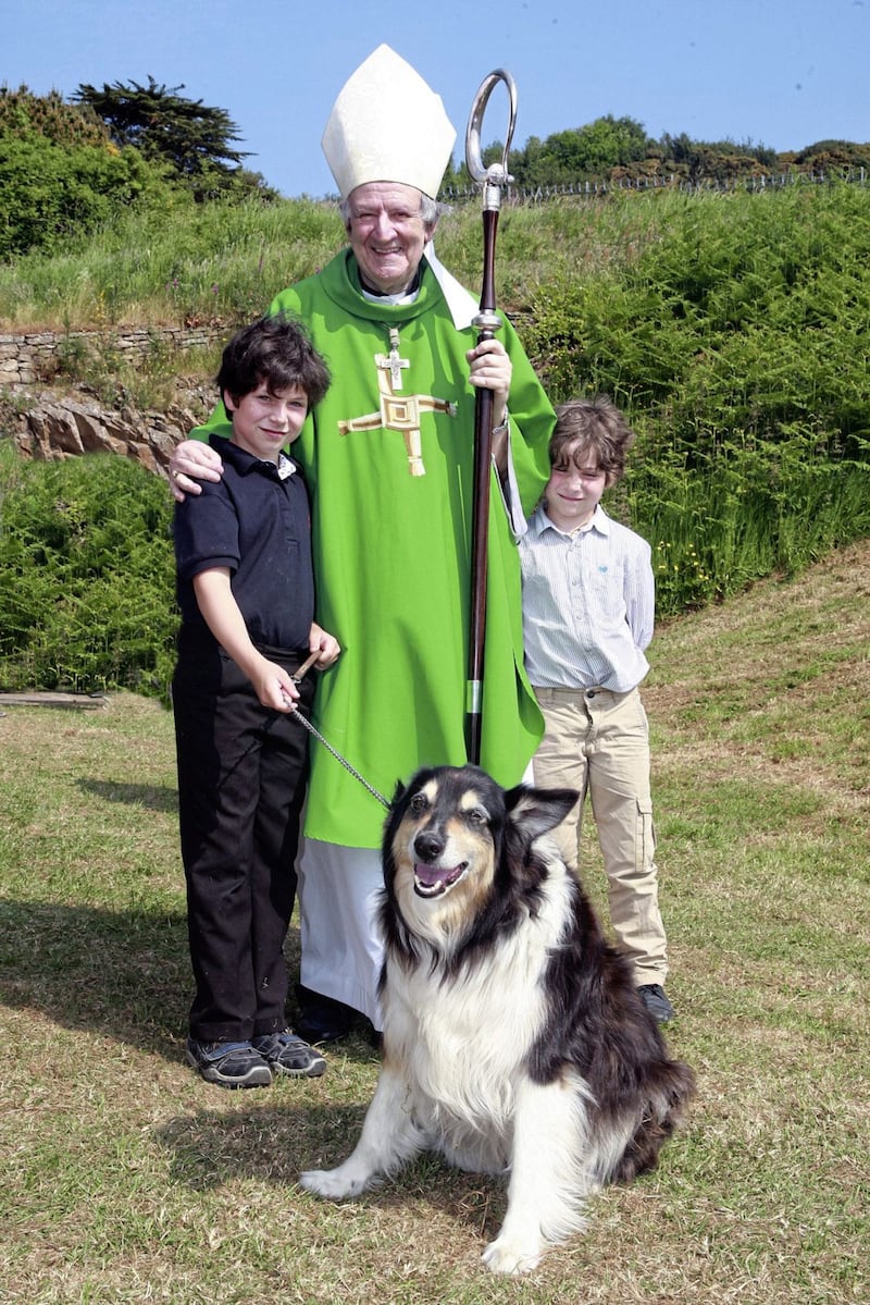 Bishop Anthony Farquhar with 10-year-old Gerard, his brother Thomas, nine, and their dog Moses. Picture by Bill Smyth 