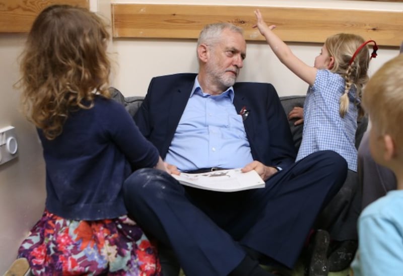 Labour leader Jeremy Corbyn reads with children as he visits Brentry Children Centre