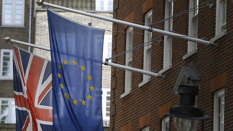 The Union flag and the European Union flag fly outside Europe House in London. A poll suggests Northern Ireland, Scotland and Wales may favour a Remain vote in the EU referendum 