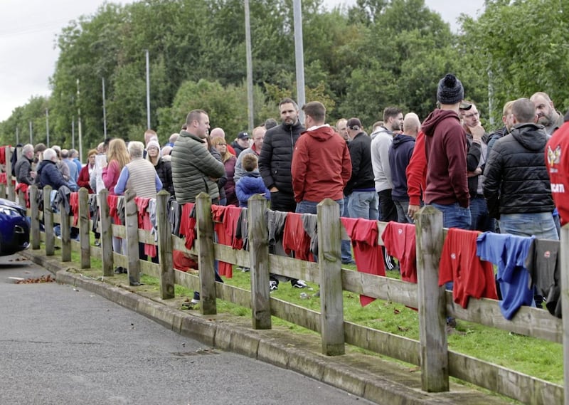 Wrightbus staff t-shirts hanging from a fence surrounding Green Pastures Church yesterday. Picture by Ann McManus. 