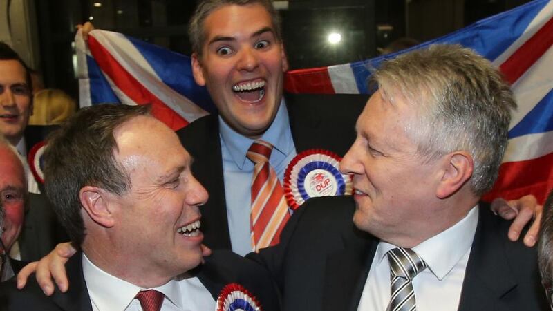 DUP Leader Peter Robinson Celebrates with MPs Nigel Dodds and Gavin Robinson  at the kings Hall in Belfast .  PRESS ASSOCIATION Photo. Picture date: Thursday May 7, 2015. See PA story ELECTION  Main . Photo credit should read: Niall Carson/PA Wire 