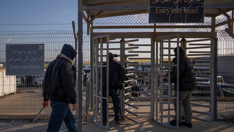 Palestinian workers enter Israel after crossing from Gaza on the Israeli side of Erez crossing between Israel and the Gaza Strip in March 2022 (Oded Balilty/AP)