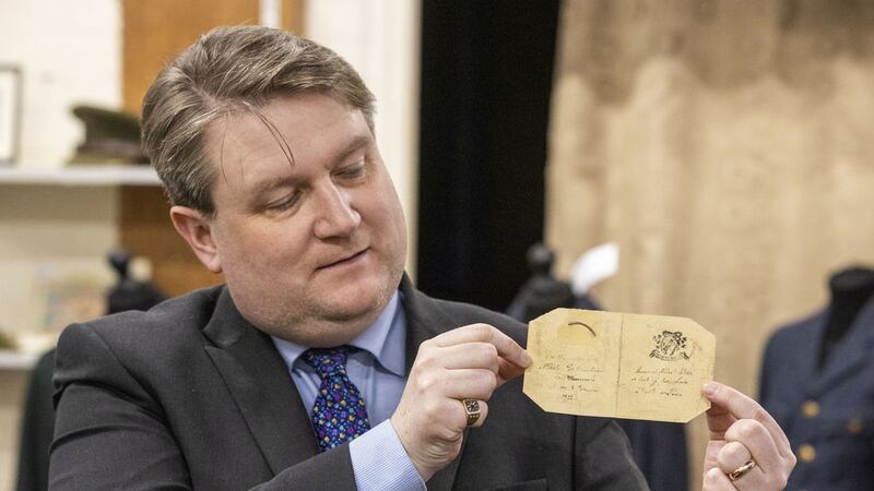 Auctioneer Karl Bennett holding a lock of hair belonging to republican leader Michael Collins, which has sold at auction for &pound;18,000, as lots linked to the War of Independence/Civil War era went under the hammer at Bloomfield Auctions in east Belfast, in their Michael Collins, Emmet Dalton and Militaria Sale. Picture by Liam McBurney/PA Wire&nbsp;