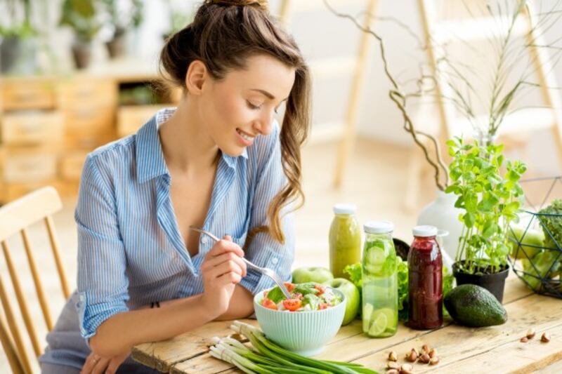 Woman eating salad.
