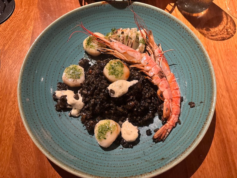 Arroz negro, black rice with prawns, scallops and calamari.