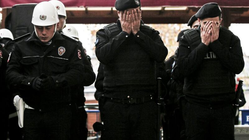 Police officers pray during the funeral of fellow officer Hasim Ustawho was killed with dozens of others late Saturday outside the Besiktas football club stadium Vodafone Arena, in Istanbul. Picture by Emrah Gurel, Associated Press