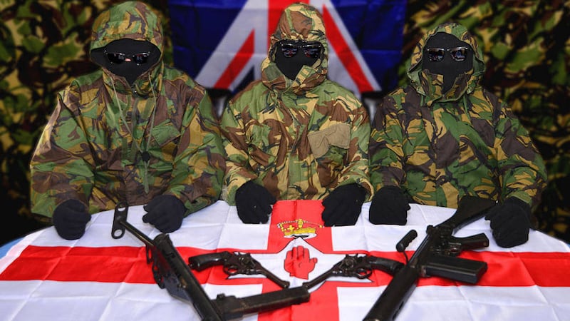 SINISTER: The raids were carried out as part of an investigation into an unnamed loyalist group that threatened police and the Parades Commission and posed with guns for this picture last week 