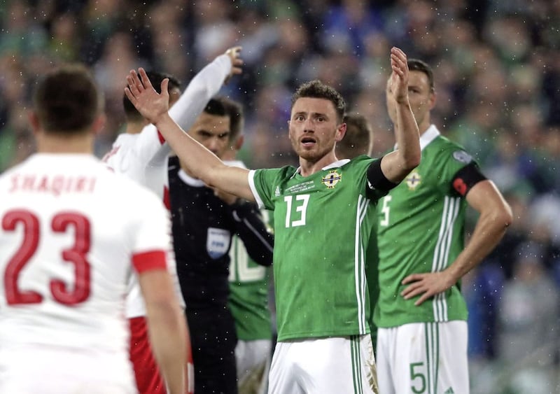 Northern Ireland&#39;s Corry Evans reacts after conceding a penalty for handball during the 2018 World Cup Qualifying Play-Off, First Leg match against Switzerland 