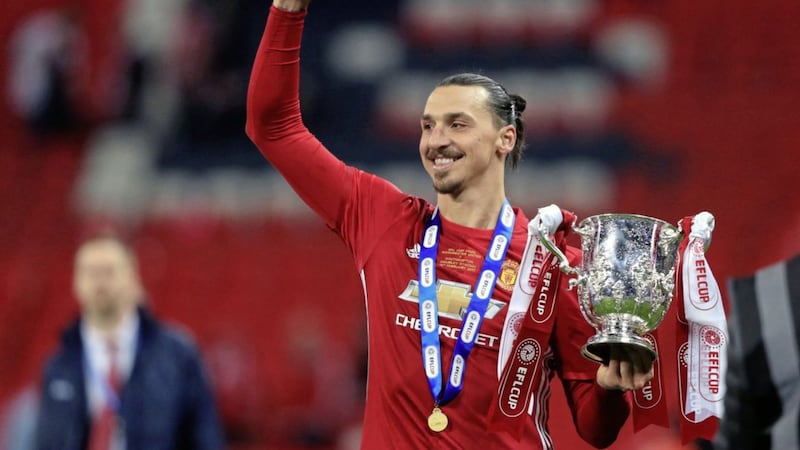 Zlatan Ibrahimovic celebrates with the EFL Cup after scoring twice in the 3-2 victory over Southampton at Wembley on Sunday Picture: PA 