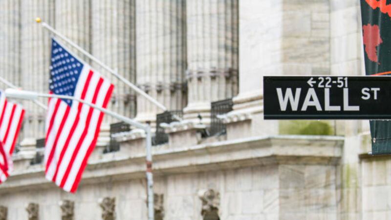 Wall street sign in New York with New York Stock Exchange background 