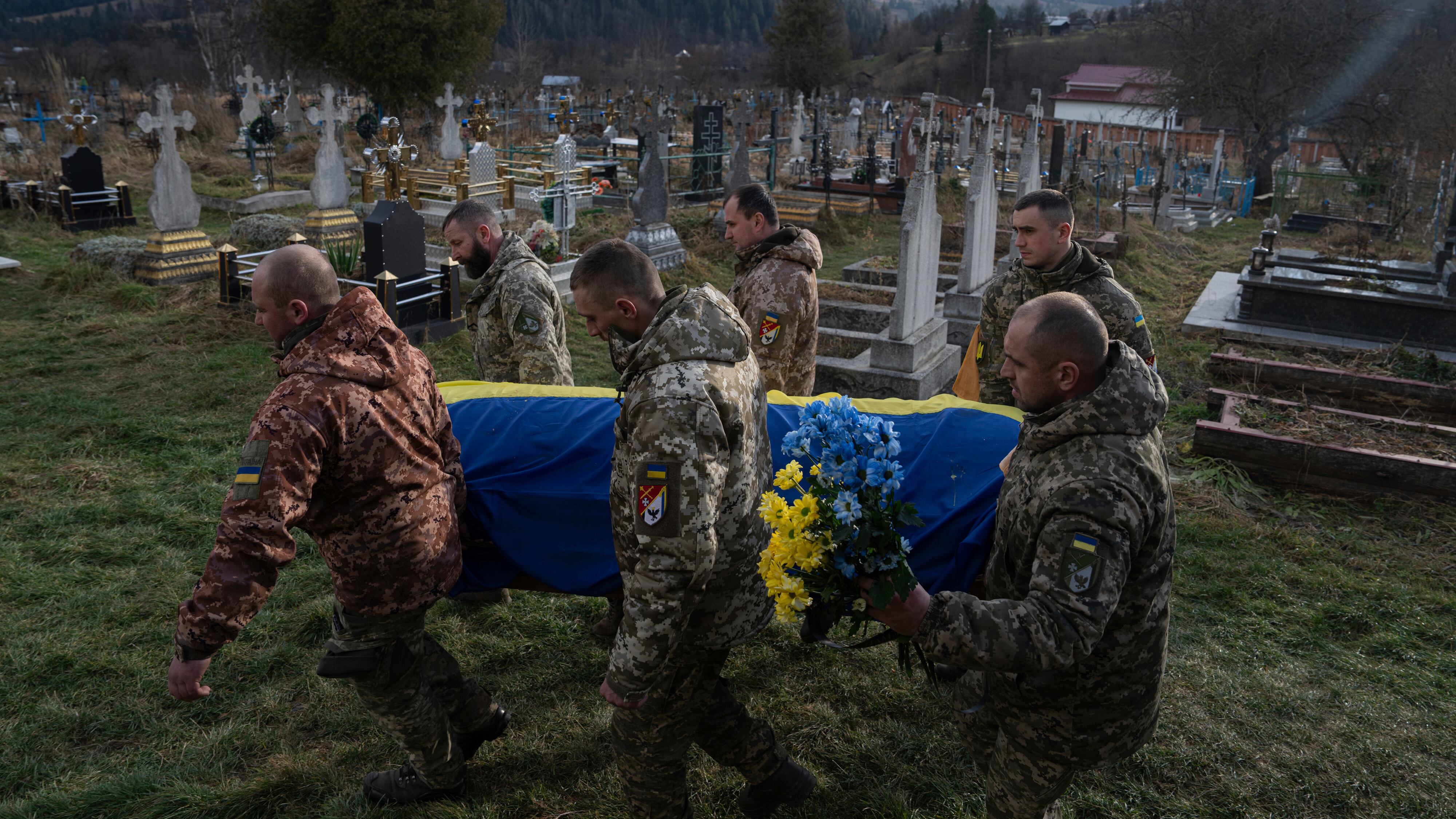 Ukrainian servicemen carry the coffin of their comrade Vasyl Boichuk, who was killed in Mykolayiv in March 2022, during his funeral ceremony on Tuesday December 26 2023 (Evgeniy Maloletka/AP)