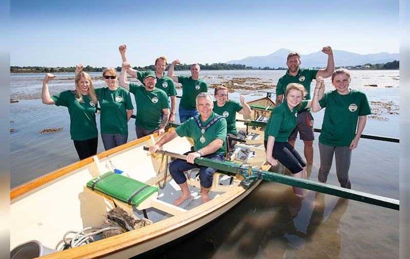 Members of Dundrum Coastal Rowing club with Mark Murnin, chairman of Newry, Mourne and Down District Council