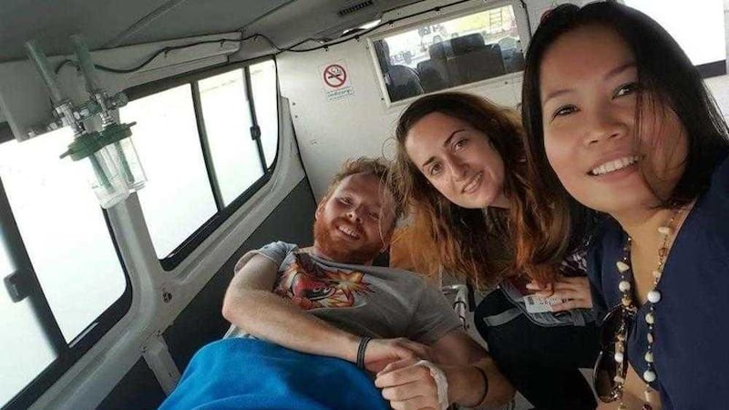 Co Down man Ben Whiteside, pictured with his girlfriend Anneka Shally and medical staff in Bangkok, Thailand, after being afflicted by a rare flesh-eating disease. 