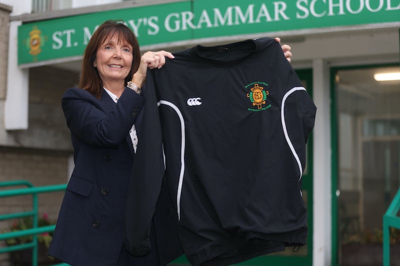 Siobhan Kelly principal of St Marys CBS on the Glen Road in west Belfast with the MacLarnon Cup top that American rapper Kanye West was pictured wearing. Picture by Mal McCann