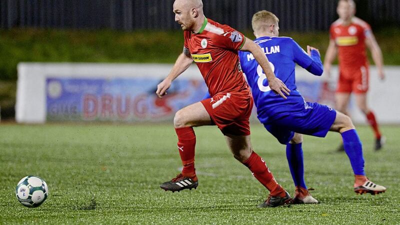 Cliftonville&#39;s Ryan Catney steals a march on Dungannon&#39;s Corey McMullan Picture by Arthur Allison. 