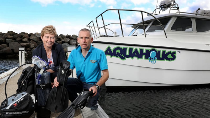Richard Lafferty, owner of Portstewart-based Aquaholics with Rhonda McClelland of Ulster Bank at the company&rsquo;s new boat, moored in Ballycastle 