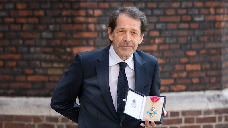 The graphic artist was awarded a CBE for services to design by the Prince of Wales during the first investiture ceremony in 15 months.