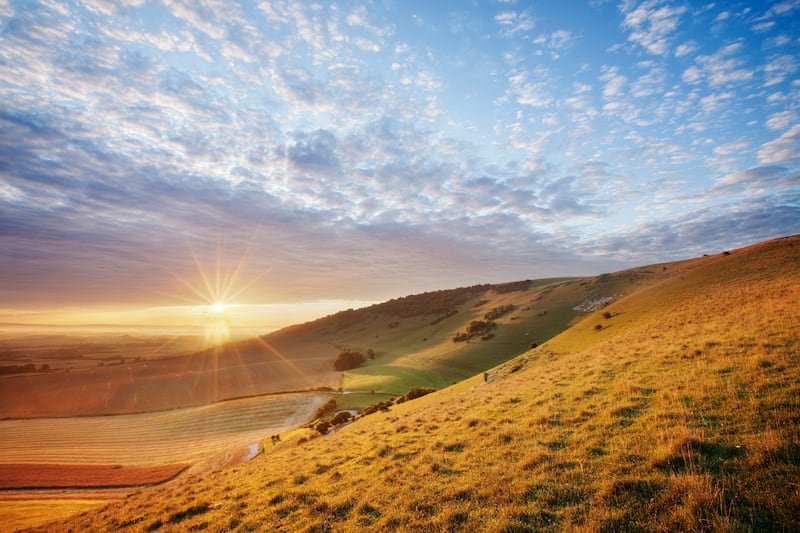Sunrise over chalk downland viewed from Wilmington Hill, Wilmington, South Downs National Park, East Sussex