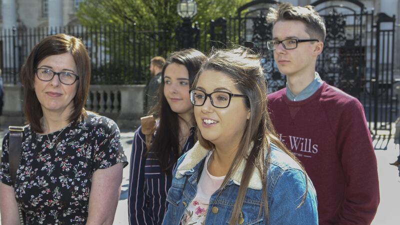 Siobhan McLaughlin with three of her children outside Belfast High Court at a previous hearing