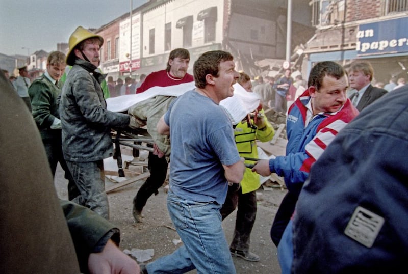 Men carrying a body on a stretcher following the 1993 Shankill bomb in which nine people were killed. Picture by Crispin Rodwell 