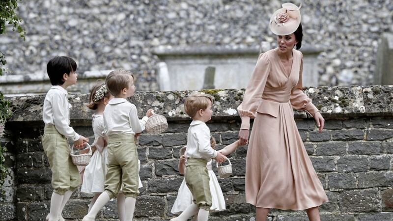 The Duchess of Cambridge has her hands full at the wedding of her sister Pippa Middleton and James Matthews at the weekend Picture: PA 