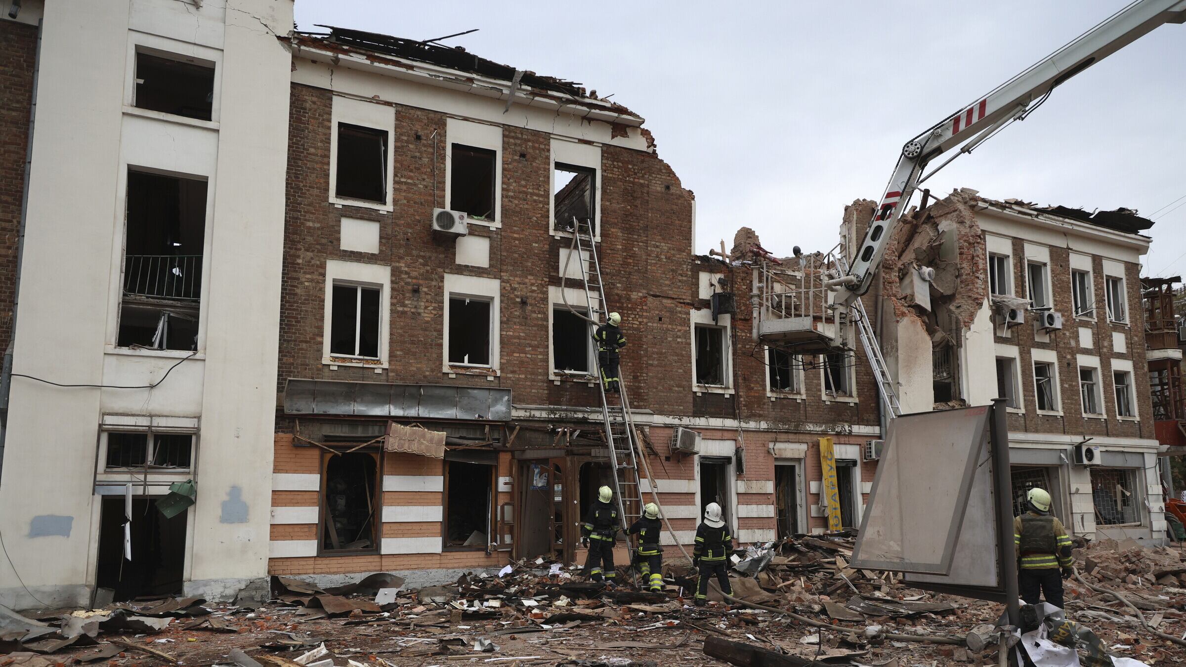 Emergency workers consider the structure of the building after the attack (AP Photo/Alex Babenko)