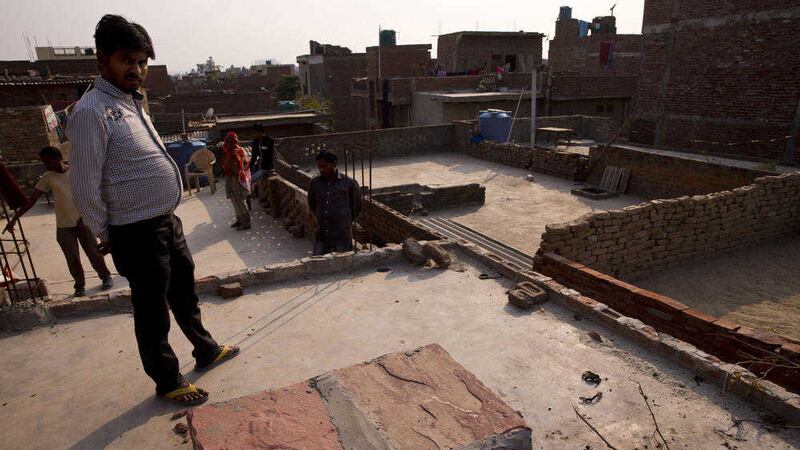 ATTACK: Relatives stand on the terrace of a house where a 15-year-old girl was set on fire after being raped at Tigri village, near Noida, a suburb of New Delhi, India PICTURE: Saurabh Das, File/AP 