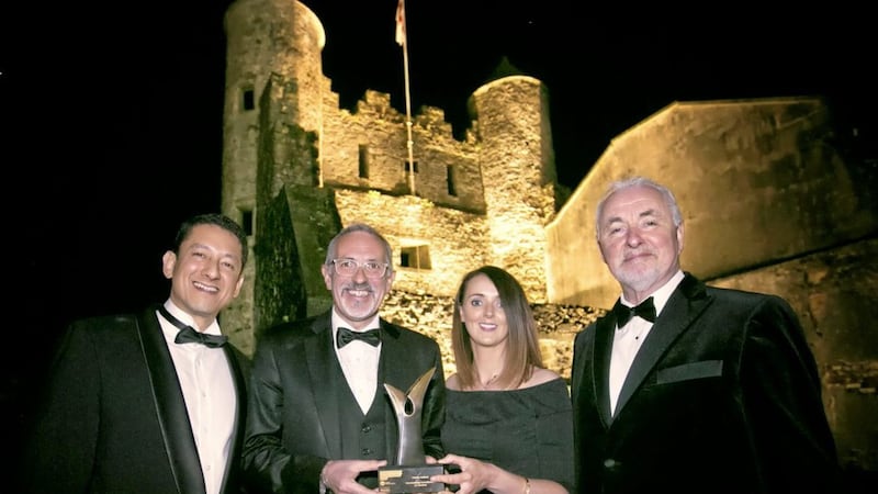 Titanic Belfast&#39;s chief executive Tim Husbands and sales and marketing executive Assumpta O&#39;Neill collect the Outstanding Contribution to Tourism award from Tourism NI chairmanTerence Brannigan (right) and Diageo&#39;s Jorge Lopes against the backdrop of Enniskillen Castle. Photo: Brian Morrison 