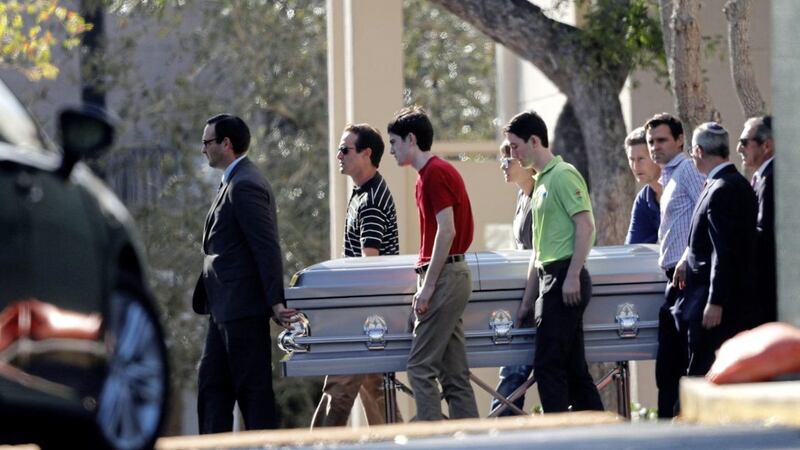 Pallbearers carry the casket of Scott Beigel, a teacher at Marjory Stoneman Douglas High School, who was killed along with 16 others in a mass shooting PICTURE: Gerald Herbert 